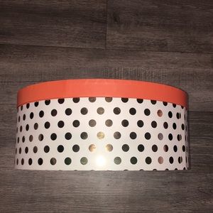 Round storage box / peachy top with  gold poke-it dots and white background.